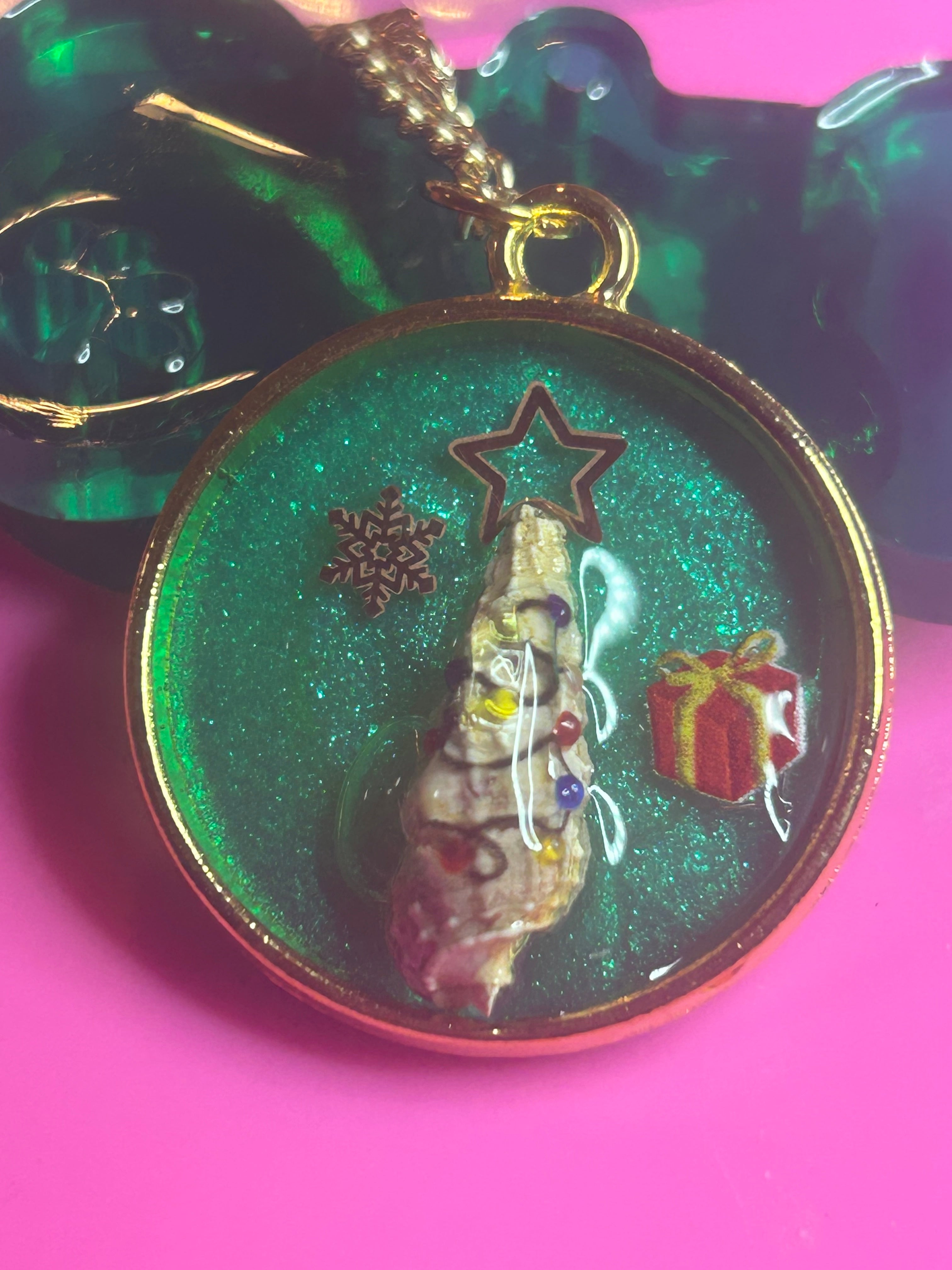 Gold circle necklace seashell Xmas tree with lights on tree, a snowflake, and a present