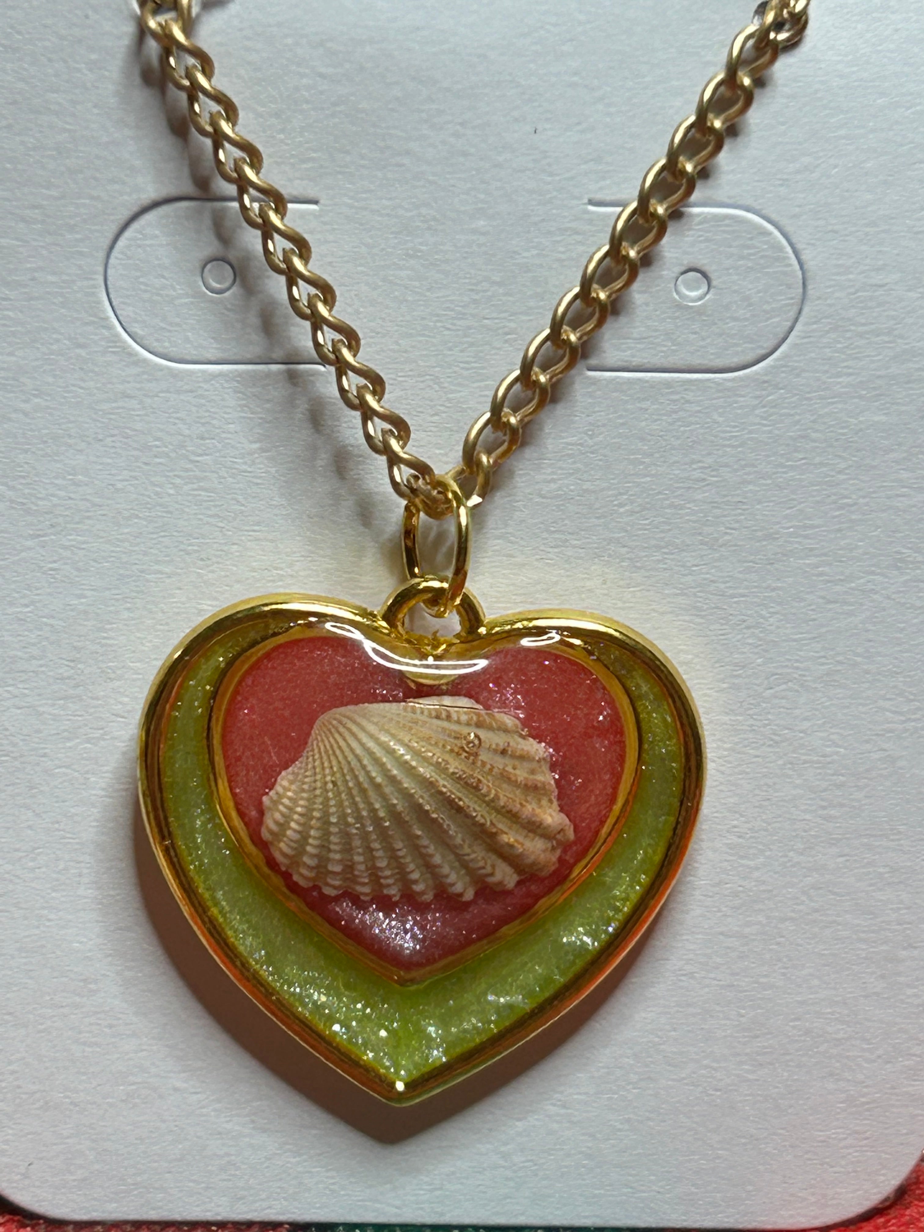 Gold Double Heart necklace with seashell and red pearlescent in middle heart and green pearlescent in outer heart