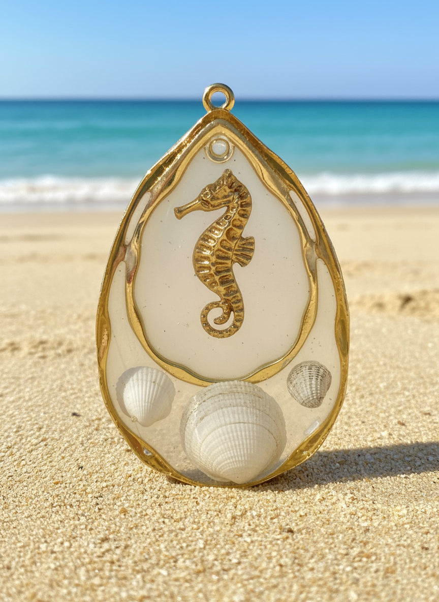 Gold seahorse pendant with shells on a blue background